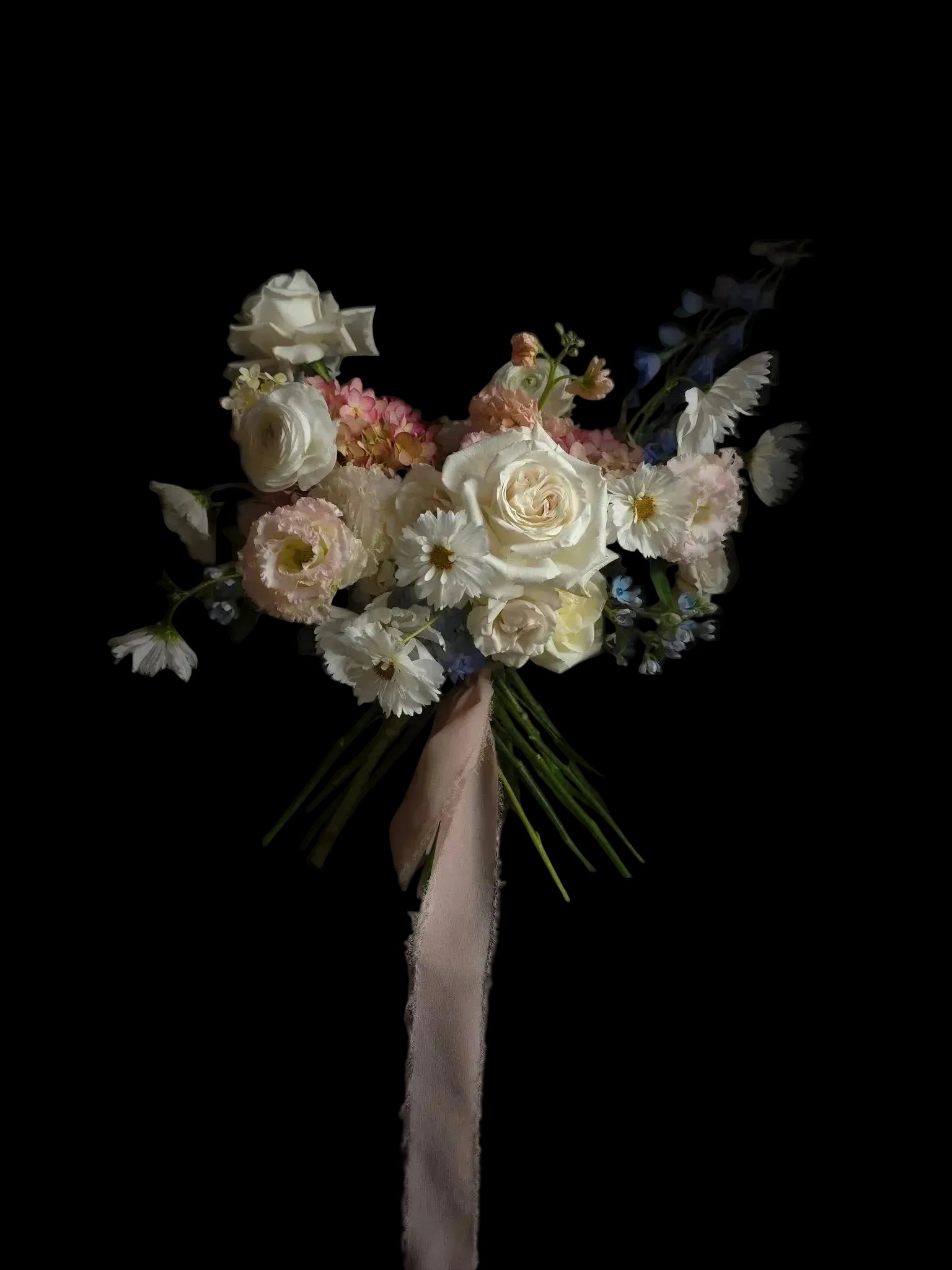 Bouquet of flowers with a pink ribbon on a black background