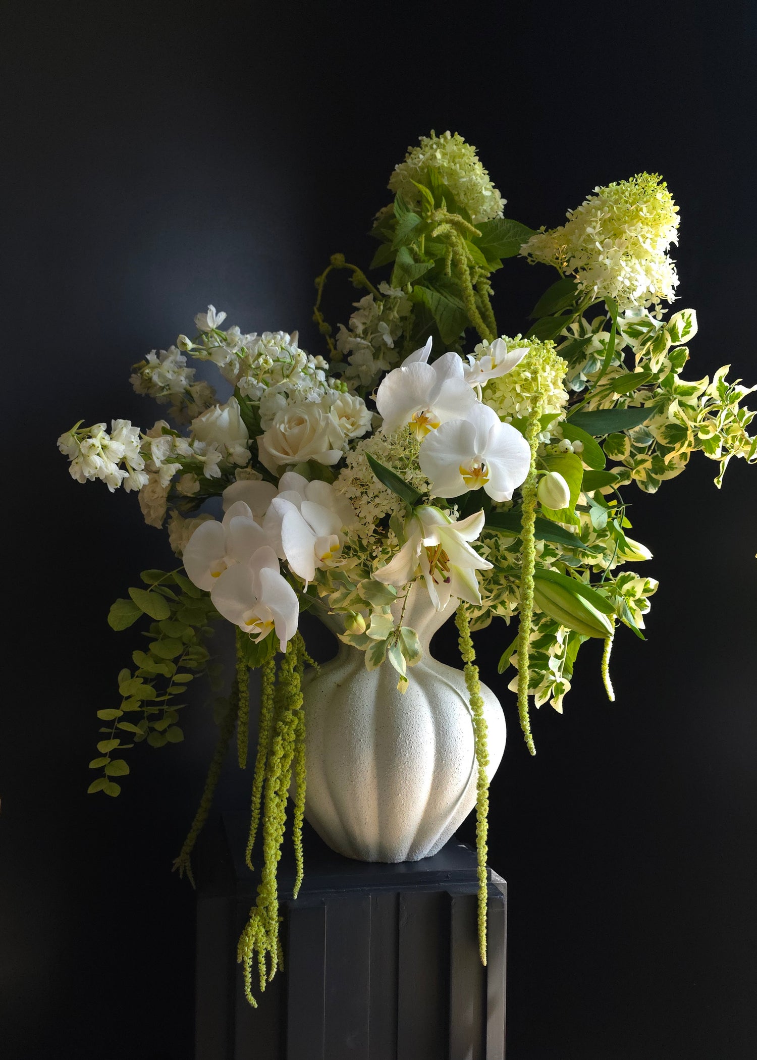 modern white and green arrangement with white orchids